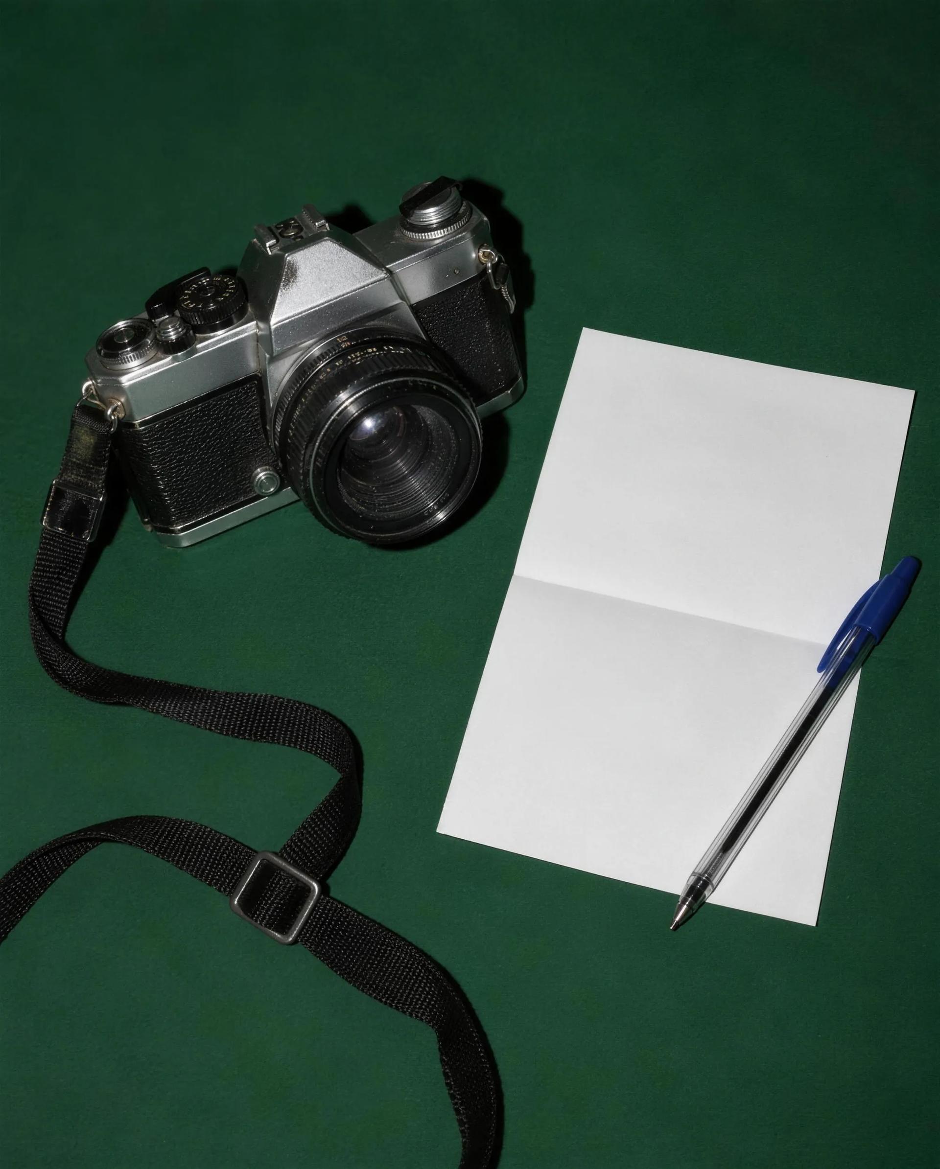 A film camera beside a signed photography contract